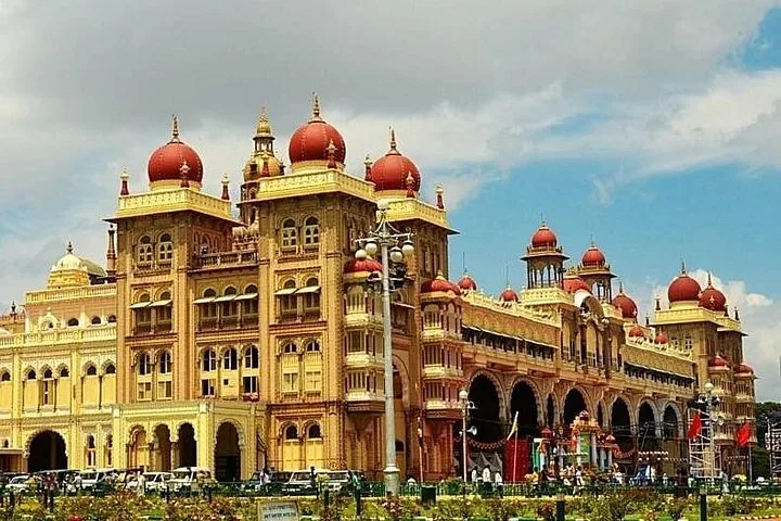 Grand facade of Mysore Palace with its iconic red domes and arches.